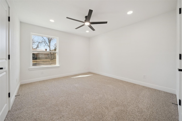 unfurnished room featuring ceiling fan and light colored carpet