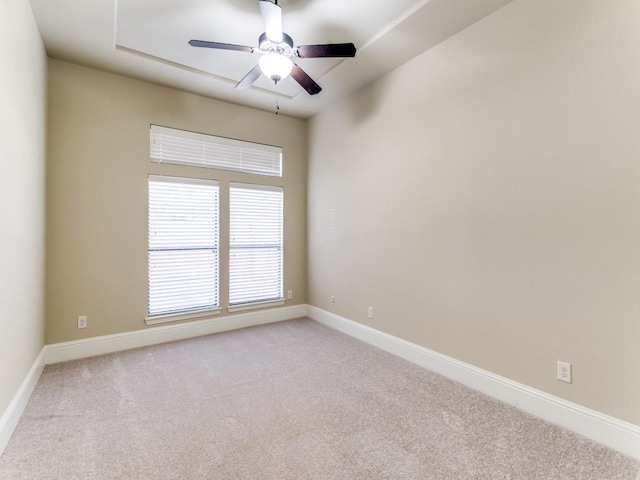 unfurnished room featuring ceiling fan and light colored carpet