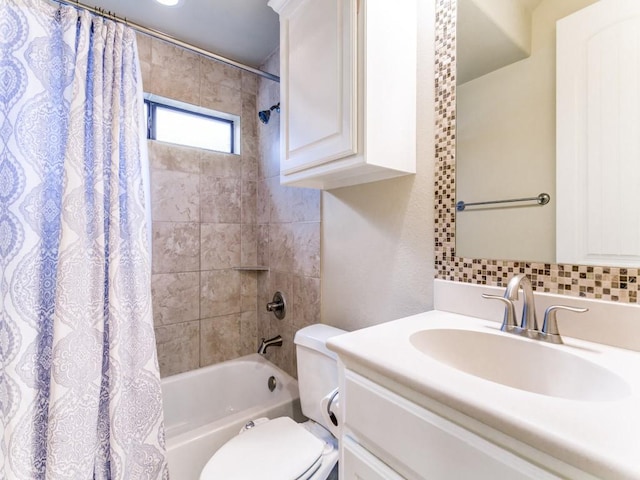 full bathroom with shower / tub combo with curtain, vanity, and toilet