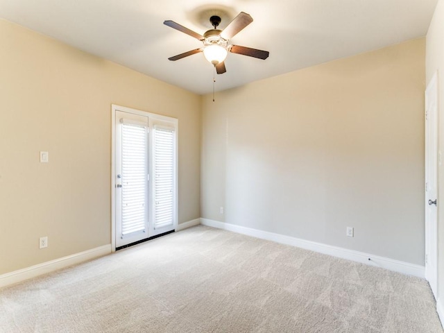 carpeted spare room with ceiling fan