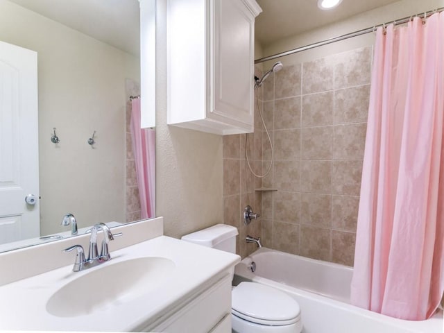 full bathroom with shower / tub combo with curtain, vanity, and toilet