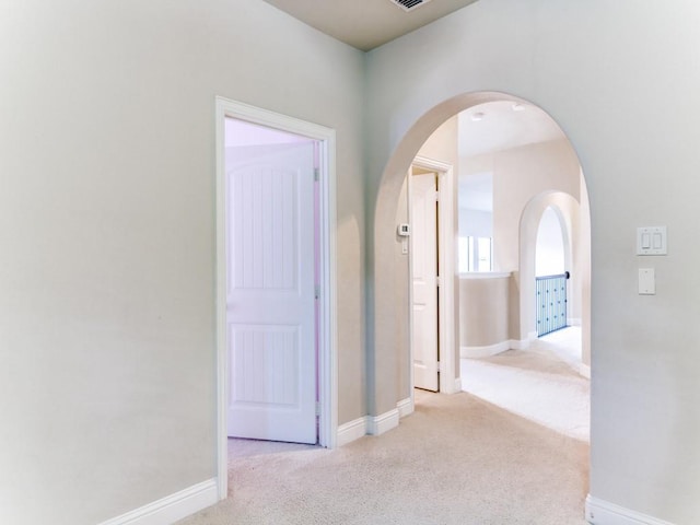 hallway featuring light carpet