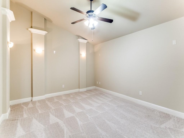 carpeted spare room with ceiling fan