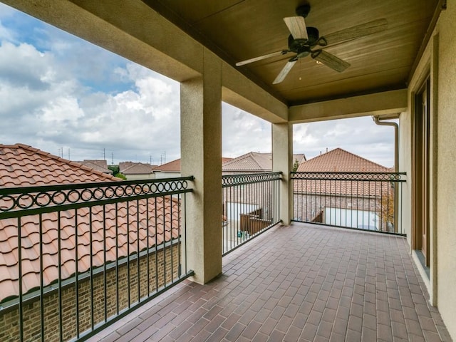 view of patio with a balcony and ceiling fan