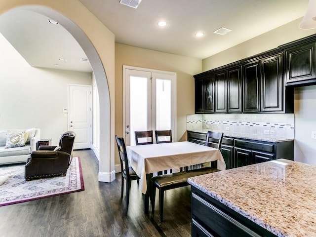 dining space with dark hardwood / wood-style flooring