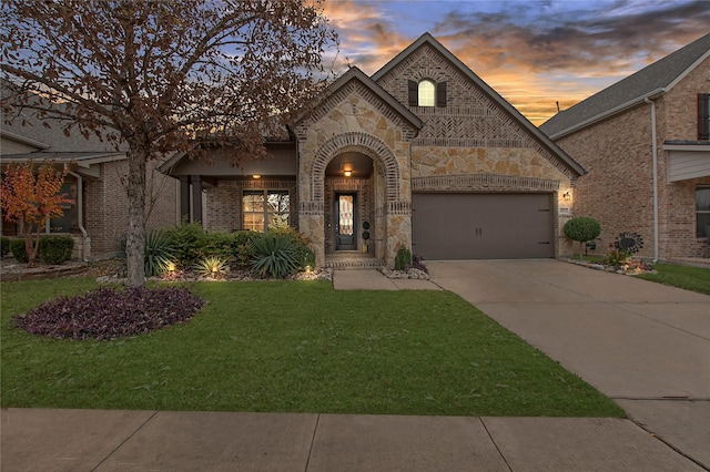 view of front facade with a yard and a garage