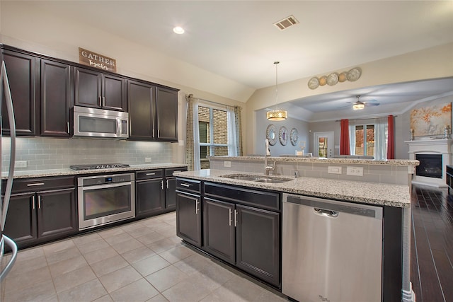 kitchen featuring ceiling fan with notable chandelier, sink, hanging light fixtures, light hardwood / wood-style floors, and stainless steel appliances