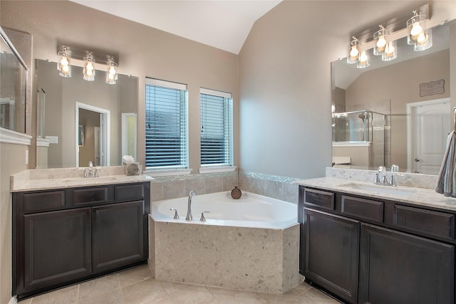 bathroom featuring plus walk in shower, vanity, tile patterned floors, and lofted ceiling