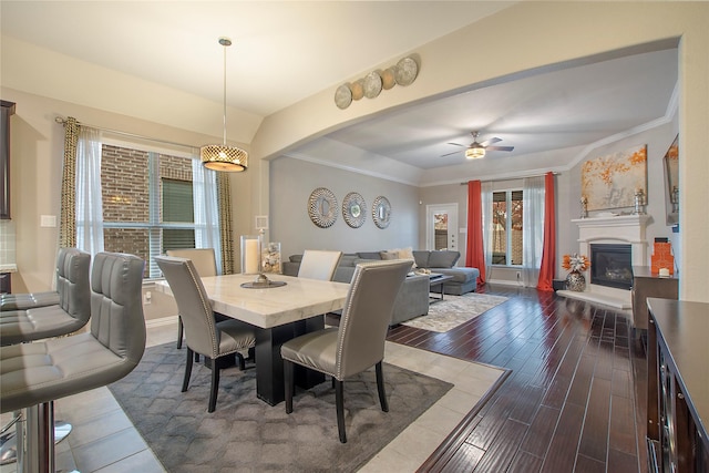 dining space with dark hardwood / wood-style floors, ceiling fan, and crown molding