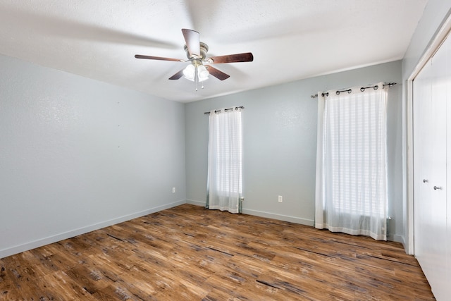 unfurnished room with wood-type flooring and ceiling fan