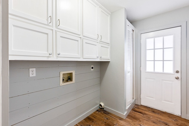 clothes washing area with hookup for an electric dryer, dark hardwood / wood-style flooring, cabinets, and washer hookup