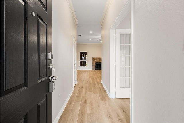 hallway featuring light hardwood / wood-style flooring and ornamental molding