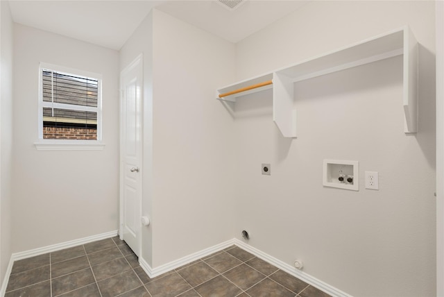 clothes washing area with washer hookup, dark tile patterned flooring, and electric dryer hookup