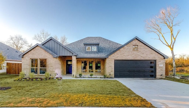 view of front of property with a front yard and a garage