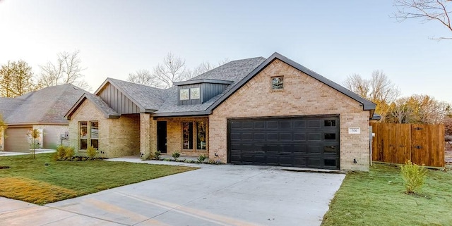 view of front of home with a front yard and a garage