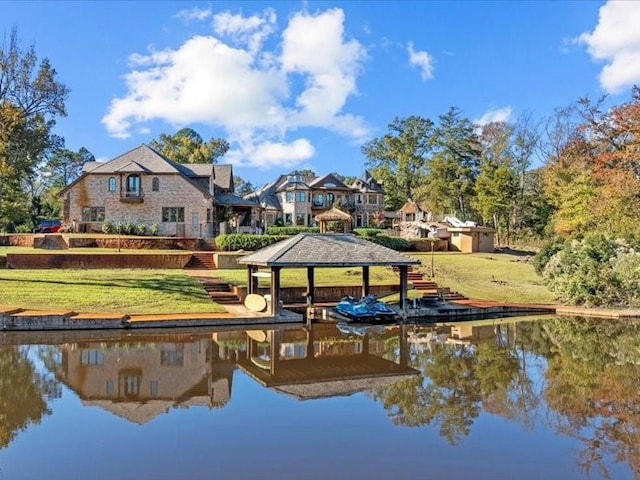 dock area with a yard and a water view