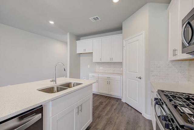 kitchen featuring sink, white cabinetry, light stone counters, light wood-type flooring, and stainless steel appliances