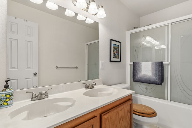 full bathroom with vanity, toilet, and combined bath / shower with glass door