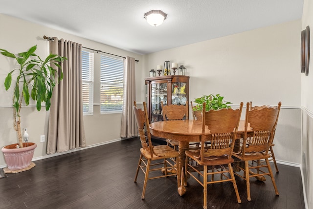 dining area featuring dark wood-type flooring