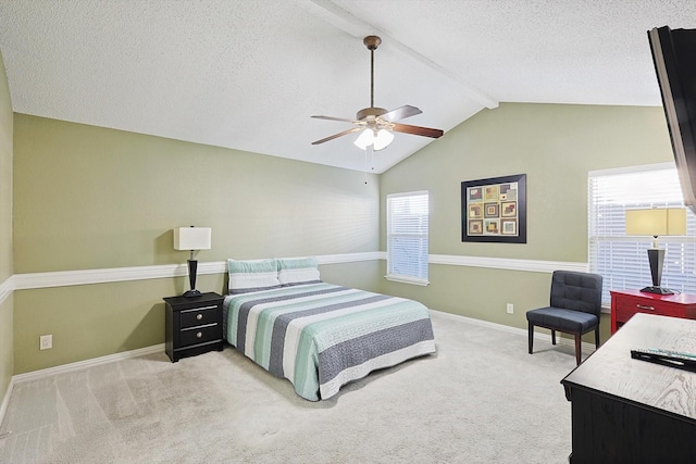 bedroom featuring vaulted ceiling with beams, ceiling fan, light carpet, and a textured ceiling