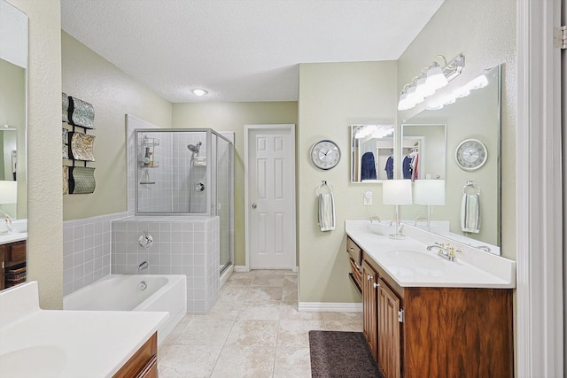 bathroom with tile patterned flooring, vanity, separate shower and tub, and a textured ceiling