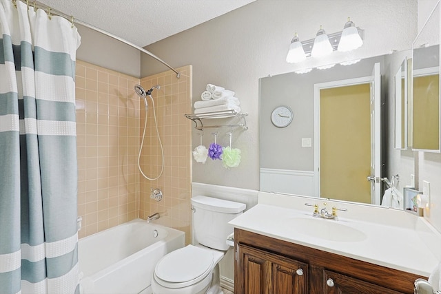 full bathroom featuring vanity, shower / bath combo, a textured ceiling, and toilet