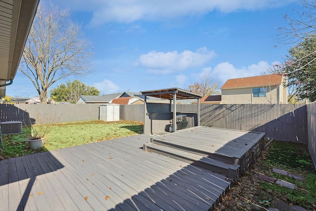 deck featuring a lawn, central AC unit, and a shed