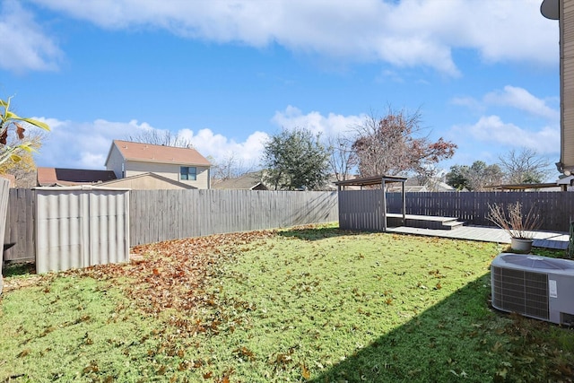 view of yard with central AC unit and a wooden deck