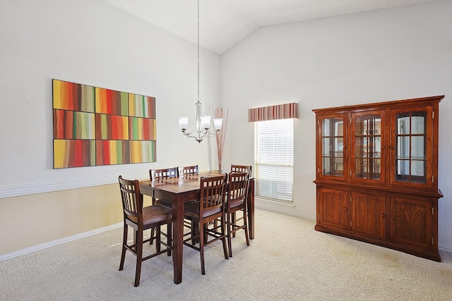 dining room with a notable chandelier, light carpet, and high vaulted ceiling