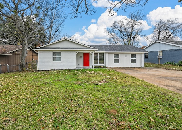 ranch-style home featuring a front yard