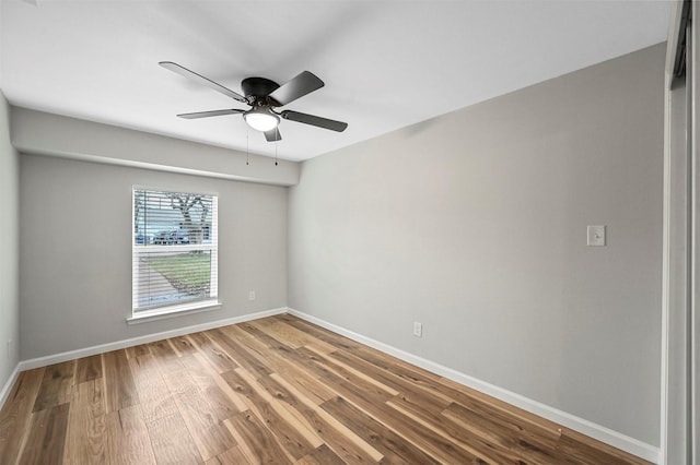 spare room with hardwood / wood-style floors and ceiling fan