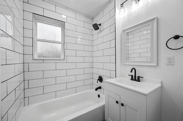 bathroom featuring tiled shower / bath combo and vanity