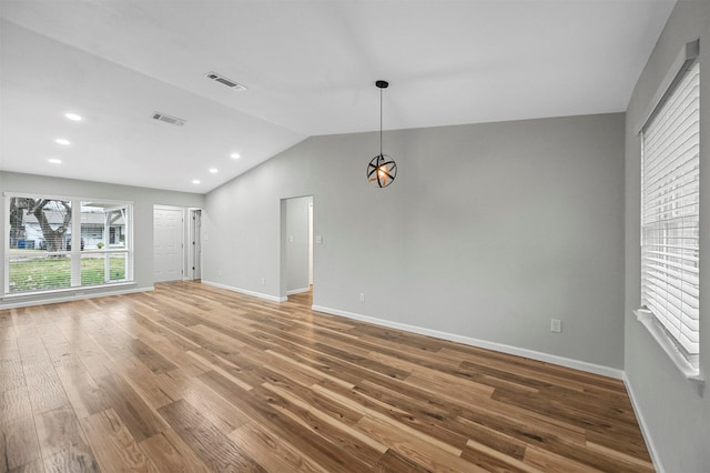 interior space with hardwood / wood-style floors and vaulted ceiling