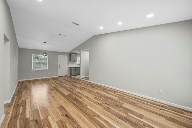 unfurnished living room featuring light wood-type flooring and lofted ceiling