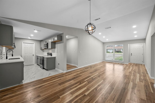 unfurnished living room with light wood-type flooring and sink