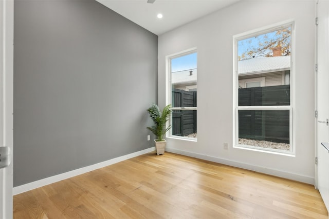 unfurnished room with ceiling fan and light hardwood / wood-style flooring