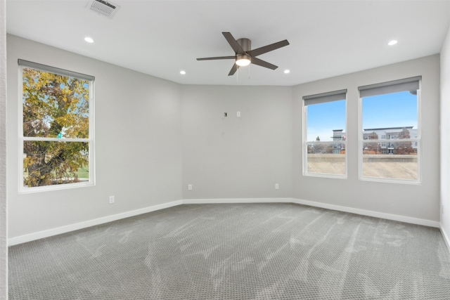 carpeted spare room featuring ceiling fan