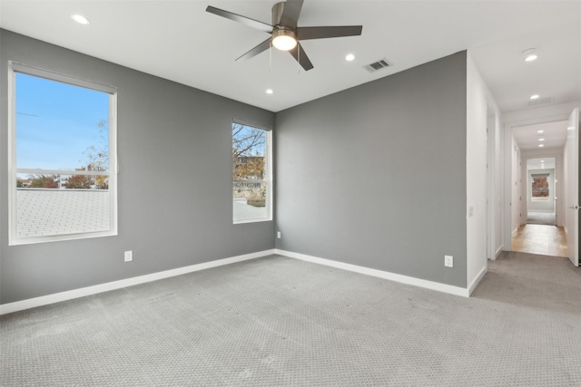 unfurnished room featuring light carpet and ceiling fan