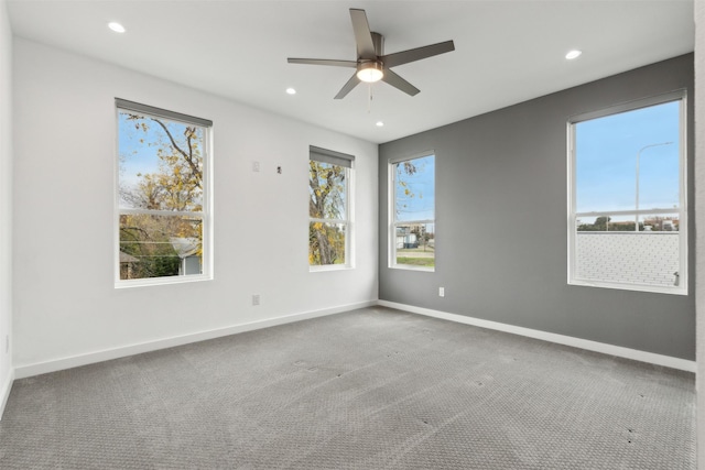 carpeted empty room featuring ceiling fan