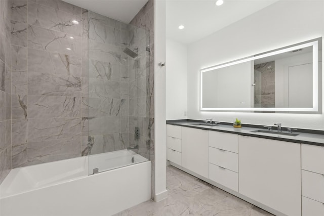 bathroom with tiled shower / bath and vanity