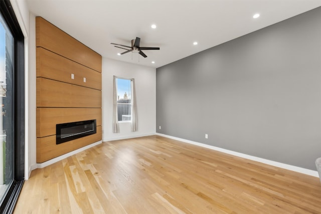 unfurnished living room with ceiling fan and light hardwood / wood-style floors