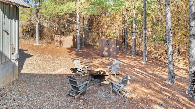 view of yard with a fire pit