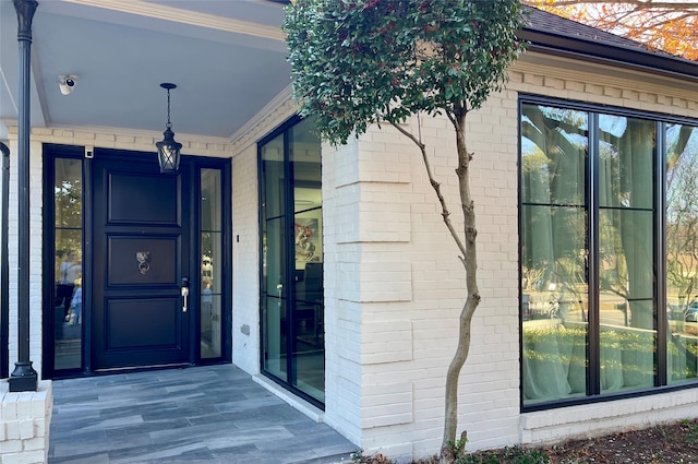 property entrance featuring brick siding