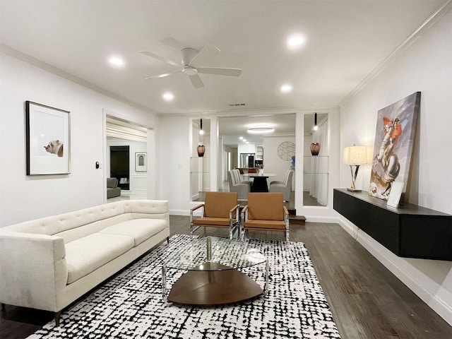 living room with ceiling fan, dark hardwood / wood-style flooring, and crown molding