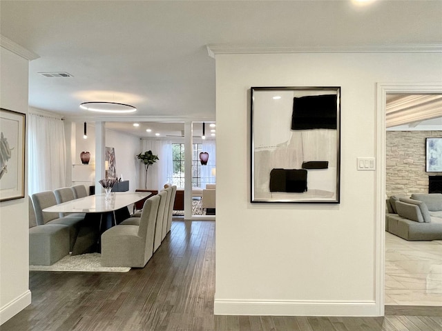 dining space with dark hardwood / wood-style floors and ornamental molding