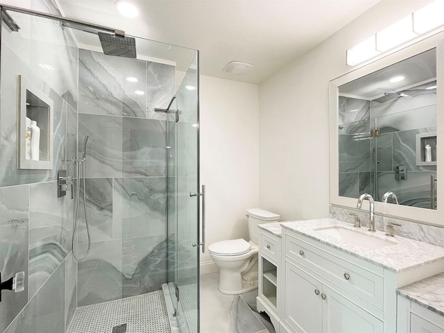 bathroom featuring vanity, toilet, and walk in shower