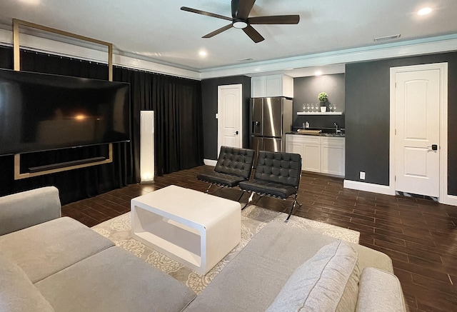 living room featuring ceiling fan and sink