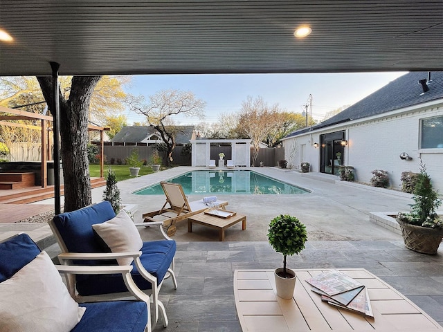 view of pool featuring a patio and a storage unit