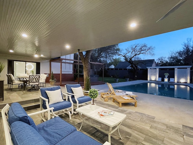 patio terrace at dusk featuring fence, outdoor lounge area, a fenced in pool, and outdoor dining space