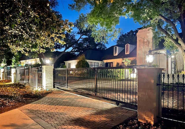 view of gate with a fenced front yard